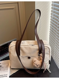 Minimalist canvas tote bag with brown leather straps and cute plush bear charm