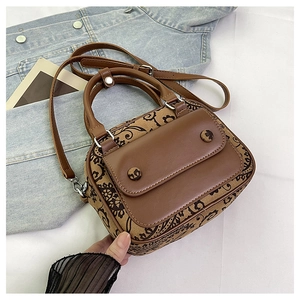 Close-up of vintage brown floral fabric and smooth leather small square handbag