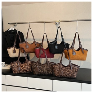 Collection of suede leopard print and solid color tote bags in various stylish autumnal tones