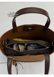 Top view of retro bucket bag showing interior capacity for phone and daily essentials