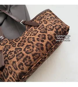Detail of leopard print tote bag showing soft fabric texture and brown leather strap