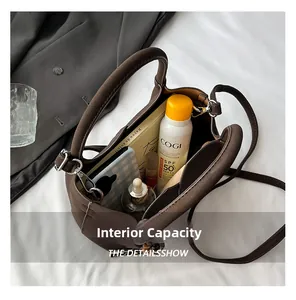 Internal capacity of dark brown matte leather bucket bag showing daily essentials storage