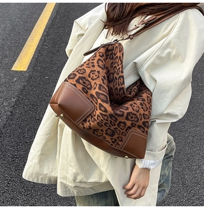 Detail of leopard print hobo bag showing brown leather panels and contrast stitching