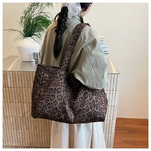 Close-up of leopard print tote bag side view showing large capacity and canvas texture