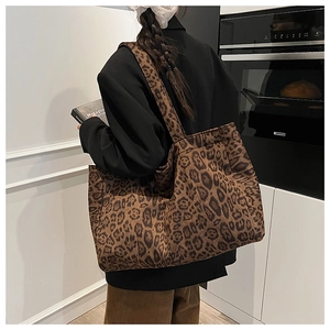 Detail shot of the large leopard print tote bag worn as a shoulder bag in daily setting