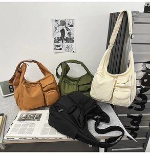 Détail de sacs bandoulière en toile multi-poches en quatre couleurs au style industriel