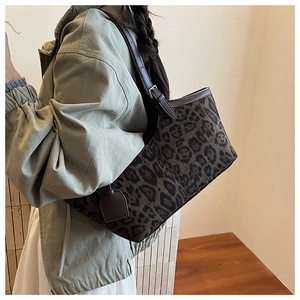 Lifestyle view of large leopard print suede tote bag with brown leather shoulder straps