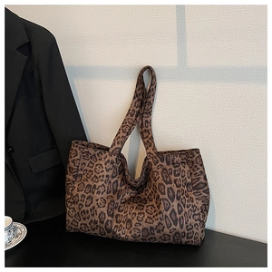Detail of large leopard print tote bag showing the texture of the thick fabric and handles