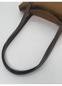 Detail of premium brown suede shoulder bag showing neat stitching on double straps