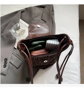 Interior view of leopard print suede bucket bag showing large storage space and capacity