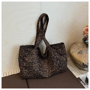 Detailed view of the leopard print pattern and fabric texture of the large tote bag