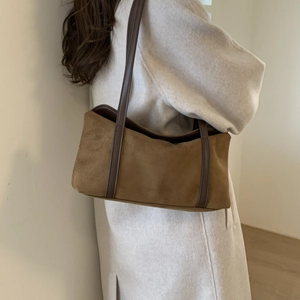 Brown faux suede underarm bag shown worn over the shoulder for a retro chic aesthetic look