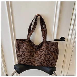 Macro shot of large leopard print tote bag with durable canvas texture and handles