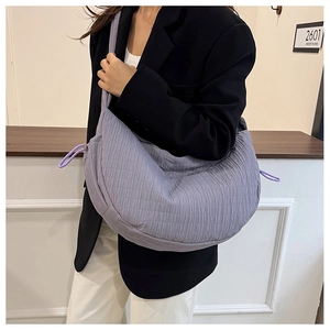 Detail of light purple pleated tote bag showing soft quilted texture and drawstring design
