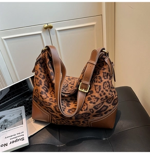 Detail of vintage leopard print tote showing plush texture and brown leather stitching
