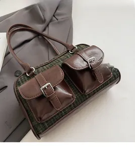 Detailed macro view of retro plaid stitching and leather fabric on the boston bag