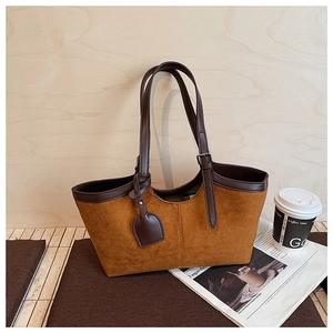 Close-up of vintage brown suede tote bag featuring deep brown leather trim and side stitching