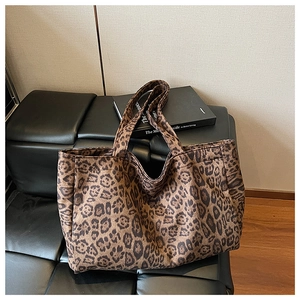Close-up detail of the leopard print pattern and durable canvas fabric of the tote bag