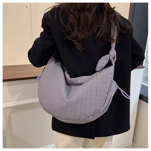 Close-up of lavender purple quilted hobo bag with drawstring and knotted strap detail