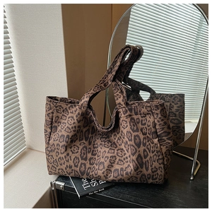 Detail of leopard print tote bag with thick canvas texture and wide shoulder strap