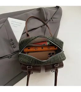 Interior view of tweed bowling bag showing spacious capacity for phone and wallet