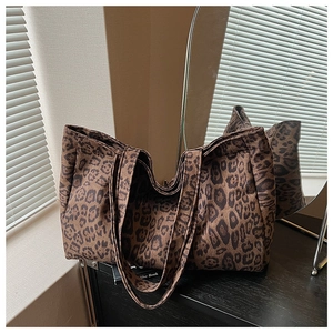 Close-up of leopard print tote bag fabric texture and sturdy canvas handle design