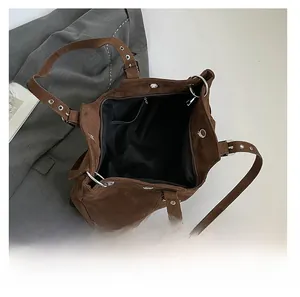 Interior view of large brown suede tote bag showing magnetic closure and zipper pocket