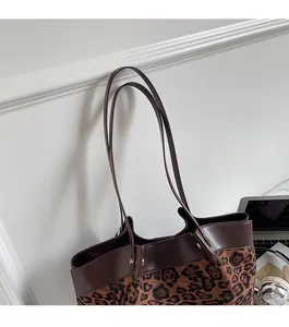 Detail of comfortable brown shoulder straps on a vintage leopard print tote bag