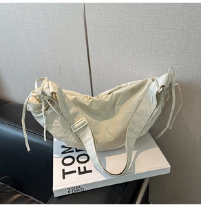 Detail of a large capacity cream dumpling bag with drawstring and adjustable wide strap