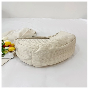 Detail of beige pleated hobo bag with soft texture for daily casual or office outfits