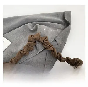 Close-up of the vintage brown suede tote bag featuring a comfortable pleated shoulder strap