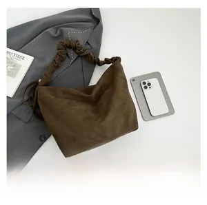 Top view of brown pleated cloud bag with soft ruched handle and matte suede texture