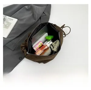 Detailed top view of large leopard tote bag interior showing laptop and daily essentials