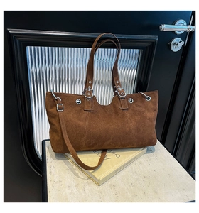 Close-up of the vintage brown tote bag texture and metallic silver grommet detailing