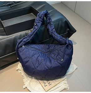 Detailed heart-shaped quilting on navy blue lightweight nylon dumpling shoulder bag