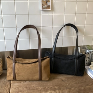 Detail view of vintage pillow shoulder bags in brown and black suede and leather finish