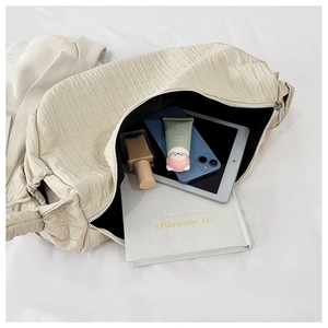 Top view of cream pleated tote bag showing large capacity for books and cosmetics