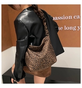 Detail view of leopard print tote bag with ruched strap on model's shoulder