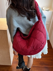 Large red heart-quilted puffer dumpling bag for women with wide shoulder strap