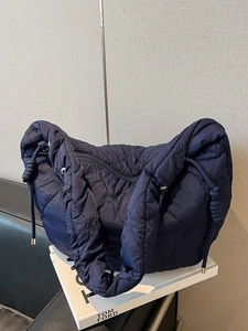 Navy blue heart-quilted tote bag with padded handles and large capacity design