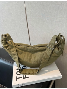 Olive green casual crescent bag with adjustable wide strap and unique pleated nylon texture