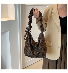 Close-up of leopard print hobo bag with unique ruched handles and silver zipper detail