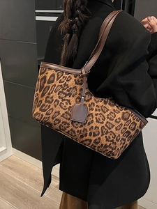 Retro leopard print faux suede tote bag with brown leather handles worn by model