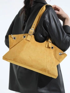Vintage ginger yellow tote bag with metal eyelets and adjustable strap on model