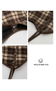 Detail of checkered tote bag showing magnetic closure and adjustable leather strap