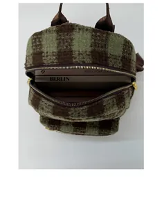 Detail view of the spacious inner compartment of the plaid winter mini backpack