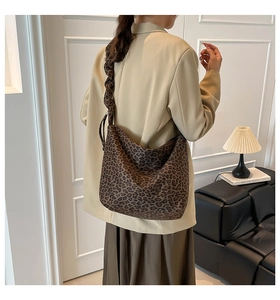 Detail of leopard print hobo bag showing large capacity and ruched shoulder strap design