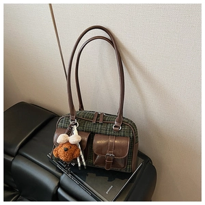 Détail du sac vintage à carreaux avec deux poches à boucles et lanières en cuir