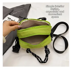 Detail view of multi-compartment green bag interior with mesh pockets and dual zippers