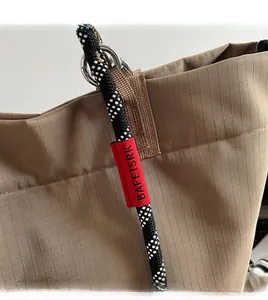 Detail of khakhi tote bag with woven rope strap and durable grid texture fabric